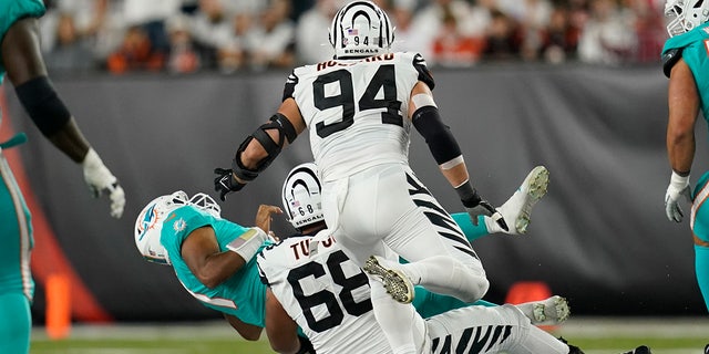 Miami Dolphins quarterback Tua Tagovailoa (1) is sacked by Cincinnati Bengals' Josh Tupou (68) during the first half of an NFL football game, Thursday, Sept. 29, 2022, in Cincinnati. 