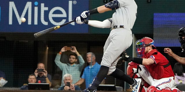 New York Yankees' Aaron Judge hits his 62nd home run of the season during the first inning of the second game of a doubleheader against the Texas Rangers in Arlington, Texas, on Oct. 4, 2022.