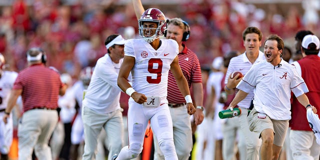 Bryce Young (9) of the Alabama Crimson Tide celebrates on the sidelines after his team scored a touchdown during a game against the Arkansas Razorbacks at Donald W. Reynolds Razorback Stadium Oct. 1, 2022, in Fayetteville, Ark. The Crimson Tide defeated the Razorbacks 49-26. 