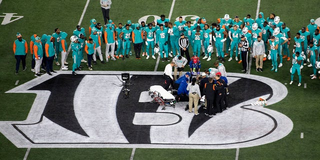 Teammates gather around Miami Dolphins quarterback Tua Tagovailoa after an injury during the first half against the Cincinnati Bengals on Sept. 29, 2022, in Cincinnati.