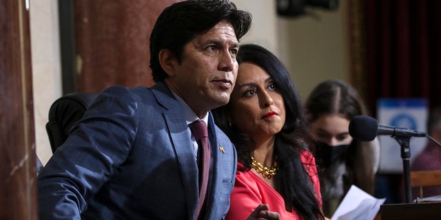 Los Angeles Councilman Kevin de León, left, and then-Los Angeles City Council President Nury Martinez confer at an Oct. 4 city council meeting. 