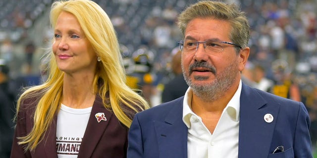 Washington Commanders owners Tanya Snyder, left, and Dan Snyder on the field before the Dallas Cowboys defeat of the Washington Commanders  25-10 at AT&amp;T Stadium on October 2, 2022 in Arlington, TX.