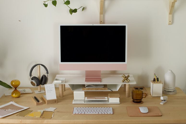 A wood desk with Gather accessories on it