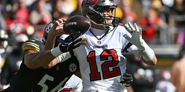 Pittsburgh Steelers linebacker Alex Highsmith (56) forces a fumble as he hits Tampa Bay Buccaneers quarterback Tom Brady during the first half in Pittsburgh on Oct. 16, 2022.