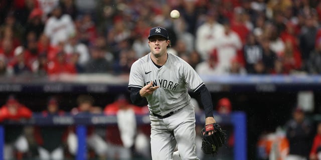 Gerrit Cole of the New York Yankees throws the ball to first base against the Cleveland Guardians during the fifth inning in Game 4 of the American League Division Series at Progressive Field on Oct.16, 2022, in Cleveland.