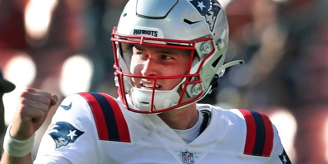 New England Patriots' Bailey Zappe pumps his fist following a touchdown.