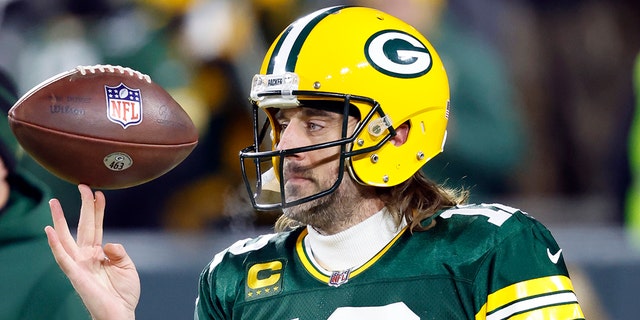 Aaron Rodgers of the Packers spins a football before the divisional playoff game against the San Francisco 49ers, on Jan 22. 2022, in Green Bay.