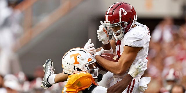 Alabama wide receiver Jermaine Burton (3) makes a catch as he's defended by Tennessee defensive back Christian Charles (14) during the second half of a game Saturday, Oct. 15, 2022, in Knoxville, Tenn. Tennessee won 52-49. 