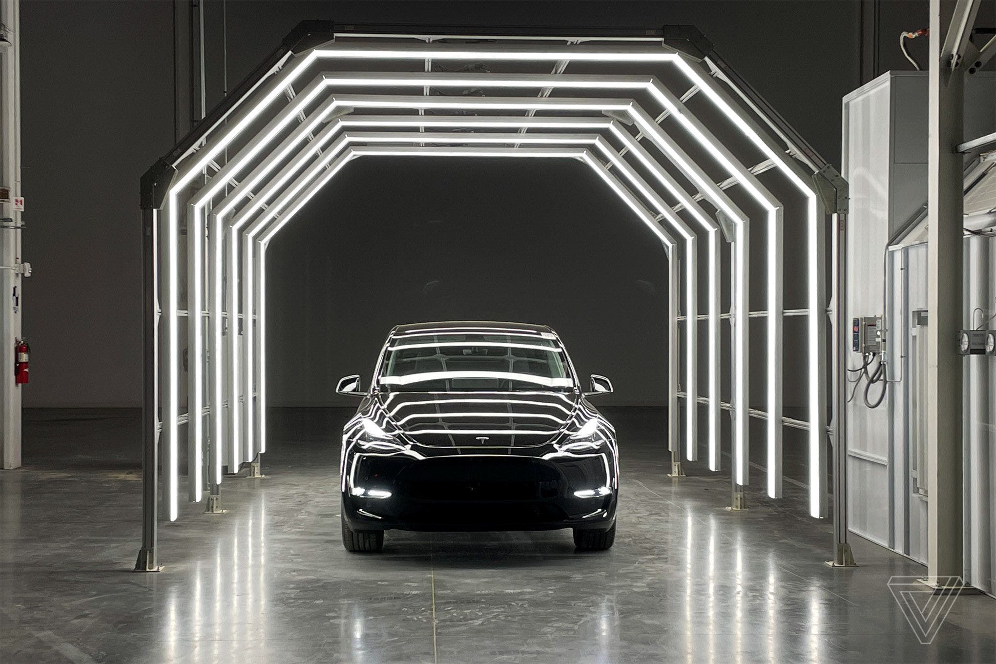 A Tesla vehicle in a lighted tunnel.