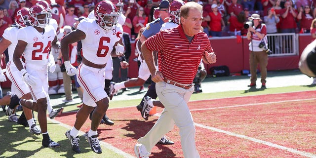 Alabama coach Nick Saban leads his team onto the field for the game between the Arkansas Razorbacks and the Alabama Crimson Tide on October 01, 2022 at Donald W. Reynolds Razorback Stadium in Fayetteville, AR 