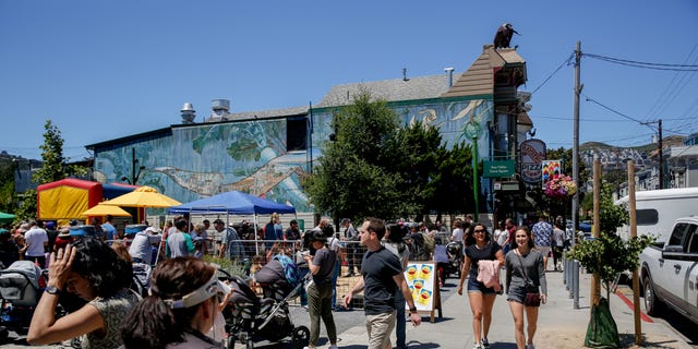 Festival goers walk along 24th Street as during the 10th annual Noe Valley neighborhood SummerFEST in the Noe Valley Town Square Sunday, June 23, 2019, in San Francisco, Calif.