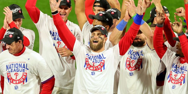 Bryce Harper #3 of the Philadelphia Phillies celebrates with teammates after defeating the San Diego Padres in game five to win the National League Championship Series at Citizens Bank Park on October 23, 2022, in Philadelphia, Pennsylvania.