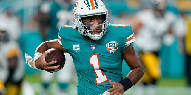 Miami Dolphins quarterback Tua Tagovailoa, #1, runs the ball during the first half of an NFL football game against the Pittsburgh Steelers, Sunday, Oct. 23, 2022, in Miami Gardens, Florida.