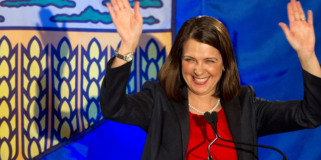 Alberta Premier Danielle Smith reacts with a smile after she lost the provincial election in High River, Alberta, on April 23, 2012.