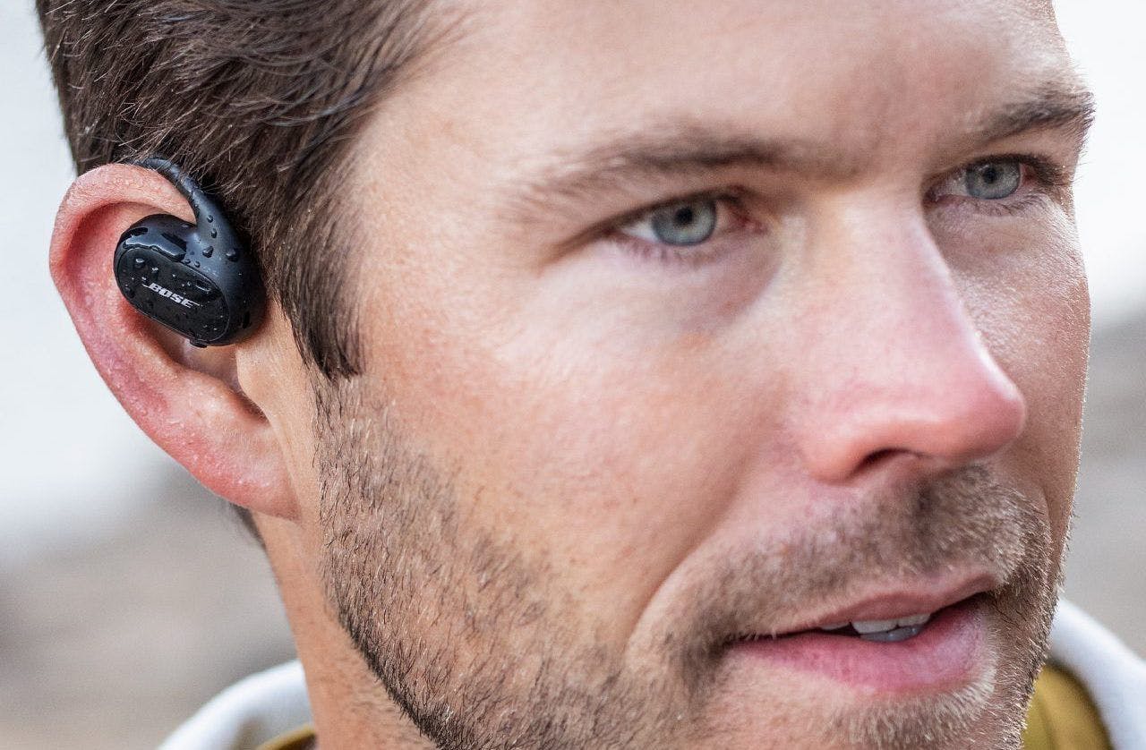 An image of Bose’s Sport Open Earbuds in a man’s right ear.