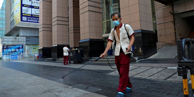 A worker sprays disinfectant around the shuttered Huaqiangbei Electronics Market following the coronavirus outbreak in Shenzhen in south China's Guangdong province on Sept. 3, 2022.