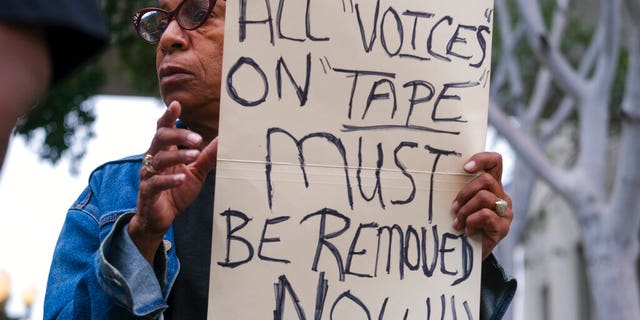 Veronica Sance holds a sign in a news conference to denounce racism and demand change in response to a recorded, racially charged leaked conversation between leaders at City Hall and the Los Angeles County. On Wednesday, the council committee censured council members Kevin de Leon, Gil Cedillo and former member Nury Martinez. 