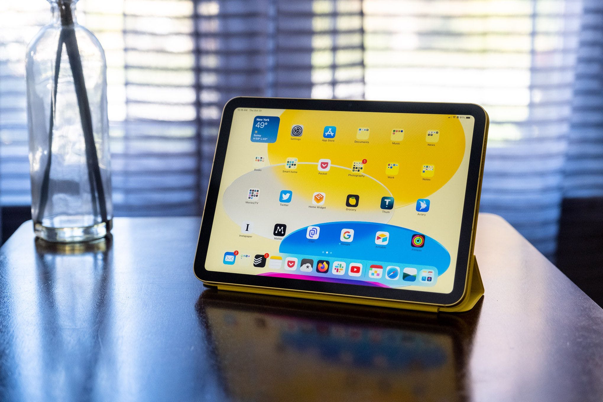 A 10th gen iPad in an Apple Smart Folio on a wood table.