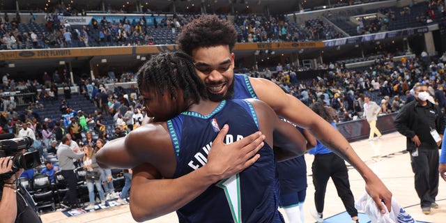 Anthony Edwards (1) of the Minnesota Timberwolves embraces teammate Karl-Anthony Towns after Game 1 of the first round of the 2022 NBA Playoffs April 16, 2022, at FedEx Forum in Memphis. 