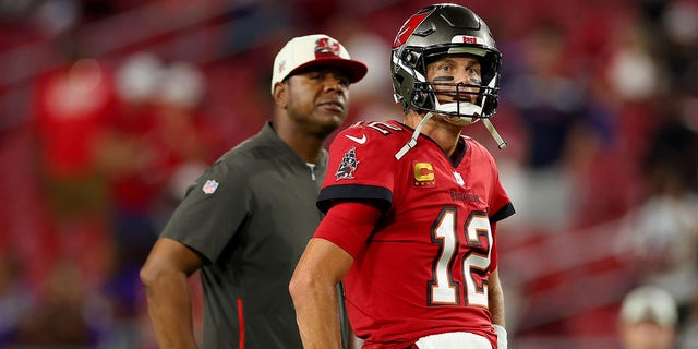 Offensive coordinator Byron Leftwich and Tom Brady, #12 of the Tampa Bay Buccaneers, look on prior to a game against the Baltimore Ravens at Raymond James Stadium on Oct. 27, 2022 in Tampa, Florida. 