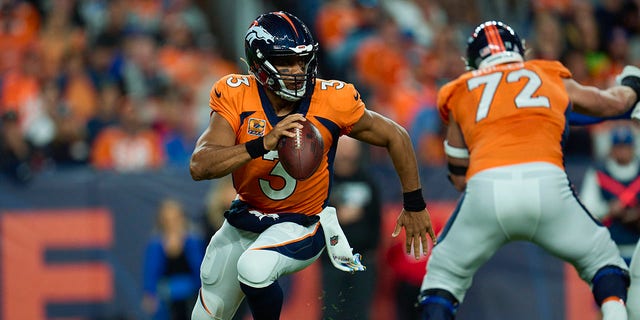 Denver Broncos quarterback Russell Wilson scrambles against the Indianapolis Colts at Empower Field at Mile High in Denver, Colorado, on Oct. 6, 2022.