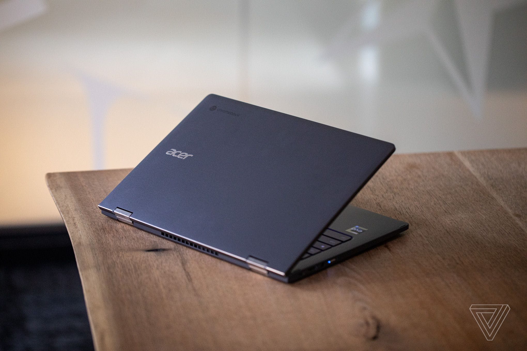 The Acer Chromebook Spin 714 half open on a wooden table seen from above.