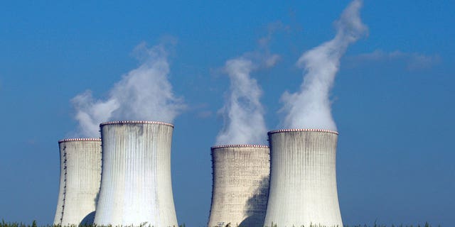 Four of the cooling towers of the Dukovany nuclear power plant rise high above the natural surroundings of Dukovany, Czech Republic. Austria is taking the European Union to court over a move that would classify natural gas and nuclear power and sustainable energies. 