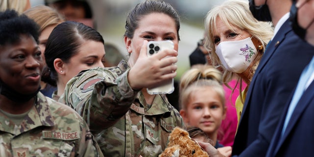 First lady Jill Biden poses for pictures with military members and their families during a gathering at Joint Base Charleston in North Charleston, South Carolina, October 25, 2021.