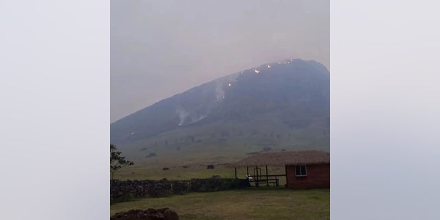 Smoke rises from a fire burning in the area of Rano Raraku volcano on Easter Island, Chile Oct. 6, 2022, in this picture obtained from social media. 