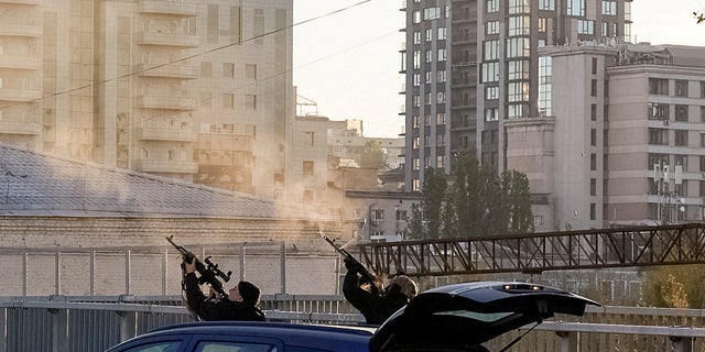 Police officers shoot at a drone during a Russian drone strike, which local authorities consider to be Iranian-made Shahed-136 unmanned aerial vehicles (UAVs), amid Russia's attack on Ukraine, in Kyiv, Ukraine October 17, 2022. i(REUTERS/Vadim Sarakhan/File Photo)