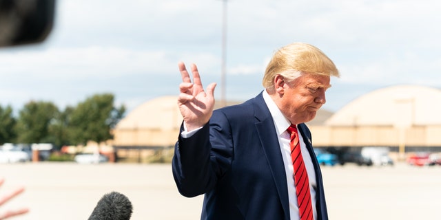 Then-President Donald Trump speaks with reporters after disembarking Air Force One at Joint Base Andrews, Maryland, on Sept. 26, 2019.