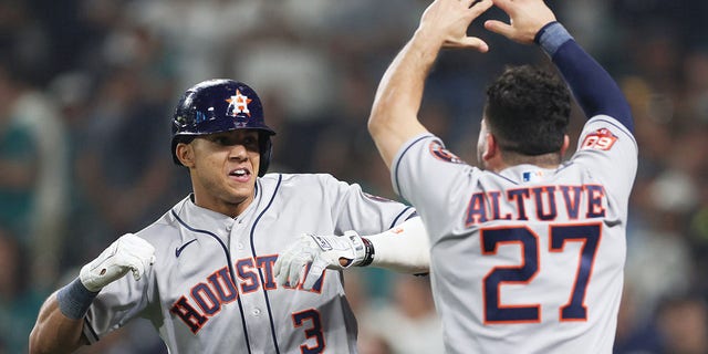 Jeremy Pena #3 of the Houston Astros reacts with Jose Altuve #27 after hitting a solo home run during the eighteenth inning against the Seattle Mariners in game three of the American League Division Series at T-Mobile Park on October 15, 2022 in Seattle, Washington.