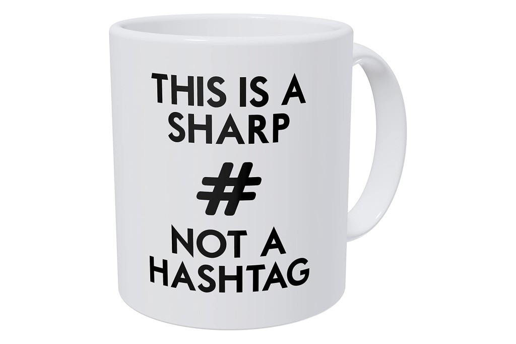 A white mug with a "The is a sharp, not a hashtag" quote in black 