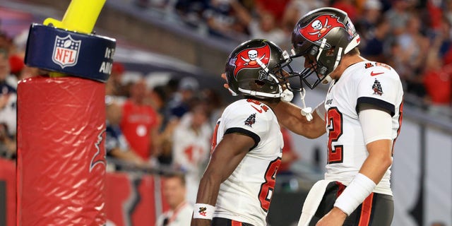 Antonio Brown and Tom Brady of the Buccaneers celebrate their touchdown against the Dallas Cowboys at Raymond James Stadium on Sept. 9, 2021, in Tampa, Florida.