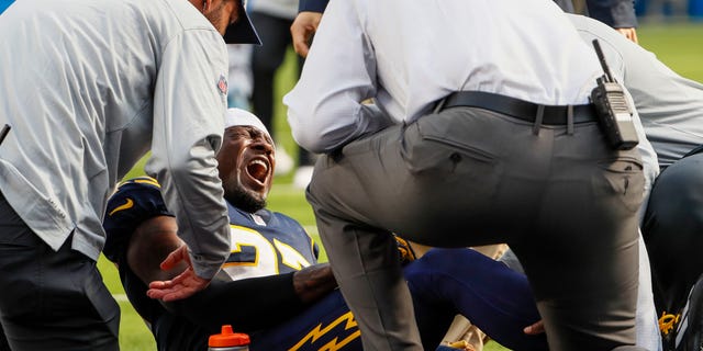 Los Angeles Chargers cornerback J.C. Jackson (27) screams out in pain after injuring himself on a play late in the first half against the Seattle Seahawks at SoFi Stadium.