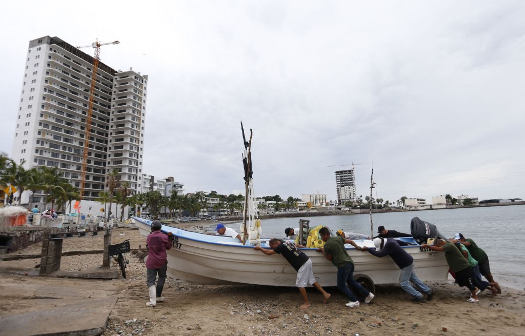 Fishermen take a boat out of the water ahead of the arrival of Hurricane Orlene, in Mazatlan on Oct. 2, 2022. 