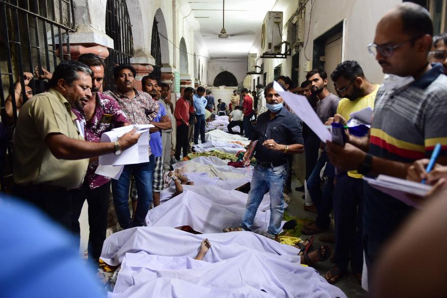 Victims of the bridge collapse are seen on the floor of the government civil hospital on Oct. 31, 2022.