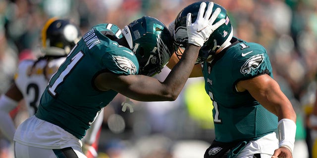 Philadelphia Eagles wide receiver A.J. Brown (11) celebrates his third touchdown reception with quarterback Jalen Hurts during the first half against the Pittsburgh Steelers on Oct. 30, 2022, in Philadelphia.