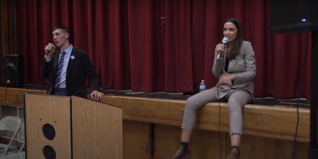 Rep. Alexandria Ocasio-Cortez, D-N.Y., attempts to reason with protesters at a town hall event in Queens.