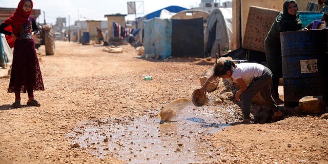 This Sunday, April 19, 2020 file photo, shows a large refugee camp on the Syrian side of the border with Turkey, near the town of Atma, in Idlib province, Syria. The head of the U.N. food agency warned of starvation and another wave of mass migration from Syria to Europe unless donors countries step up financial assistance to the war-ravaged country. 