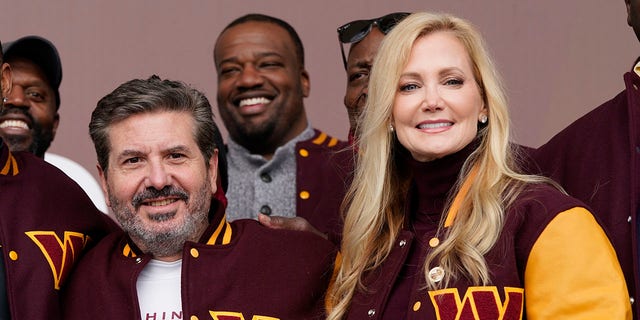 Dan and Tanya Snyder, co-owners and co-CEOs of the Washington Commanders, pose for photos after unveiling their NFL football team's new identity Feb. 2, 2022, in Landover, Md.