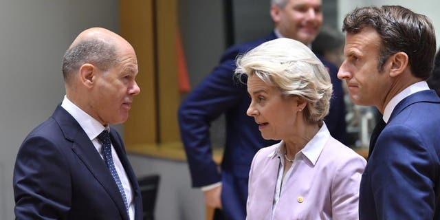 European Commission President Ursula von der Leyen and French President Emmanuel Macron speak with German Chancellor Olaf Scholz at an EU summit in Brussels, June 23, 2022.