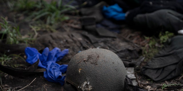 A damaged helmet is seen on the ground of a site where four bodies of Ukrainian soldiers were found in an area near the border with Russia, in Kharkiv region, Ukraine, on Sept. 19, 2022.