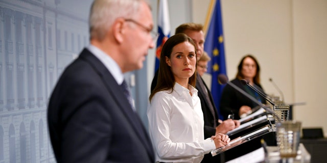 Finland's Prime Minister Sanna Marin looks at Finland's Foreign Minister Pekka Haavisto as he speaks during a press conference by the Government of Finland in Helsinki, Finland, Wednesday Sept. 28, 2022. The ministers shared views to current security issues concerning Nord Stream gas pipelines and restrictions on the issuing of visas to Russian citizens.