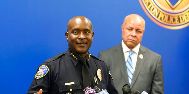 Stockton Police Chief Stanley McFadden, left, flanked by Stockton City Manager Harry Black, right, updates reporters about the investigation into the fatal shooting of six men and the wounding of one woman dating back to last year, during a news conference in Stockton, Calif., Tuesday, Oct. 4, 2022.