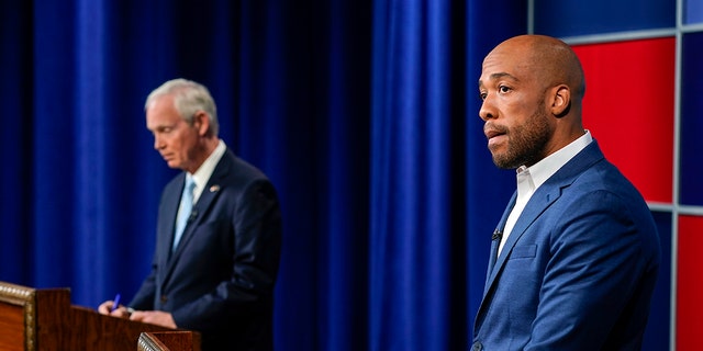 U.S. Sen. Ron Johnson, R-Wis., left, and his Democratic challenger Mandela Barnes wait for start of a televised debate, Friday, Oct. 7, 2022, in Milwaukee. 