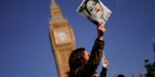 People take part in a protest against Iran's government in Parliament Square, in London, Saturday, Oct. 8, 2022.