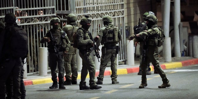 Israeli security forces patrol next to the scene of a shooting attack near the Shuafat refugee camp in Jerusalem, Saturday, Oct. 8, 2022.