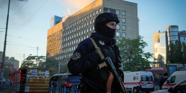 Police block the perimeter at the scene of Russian shelling in Kyiv, Ukraine, Monday, Oct. 17, 2022, after some explosions rocked Kyiv in the early morning.