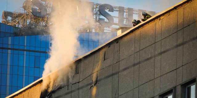 Firefighters work at the scene of Russian shelling in Kyiv, Ukraine, Monday, Oct. 17, 2022, amid apparent airstrikes from Russians.